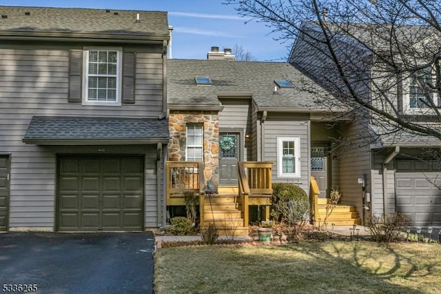 view of front of property with a garage and a front lawn