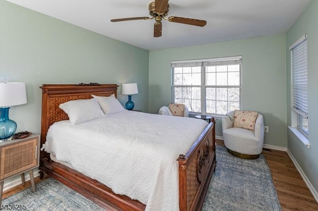 bedroom with ceiling fan and dark hardwood / wood-style floors