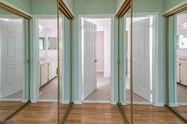 hall with sink and light hardwood / wood-style flooring