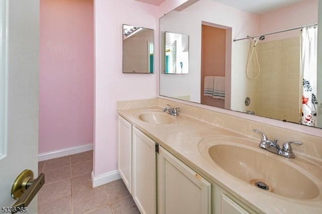 bathroom featuring tile patterned flooring, vanity, and a shower