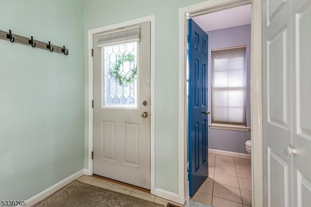 doorway with light tile patterned floors