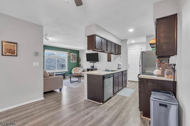 kitchen featuring sink, ceiling fan, appliances with stainless steel finishes, dark brown cabinets, and light hardwood / wood-style floors