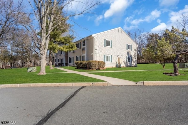 view of side of home with a lawn