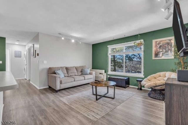 living room with track lighting and light hardwood / wood-style floors