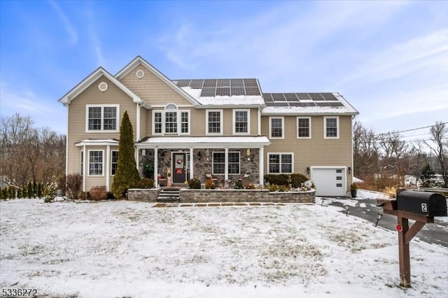 view of front of home featuring a garage and solar panels