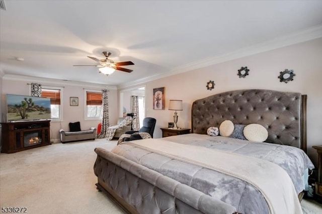 carpeted bedroom with crown molding and ceiling fan