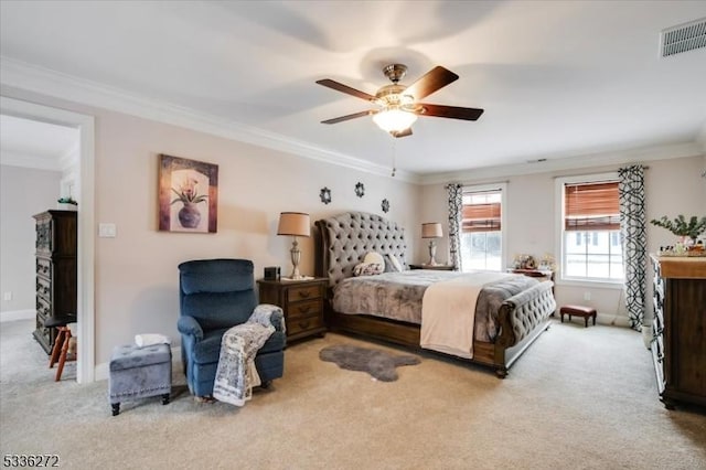 carpeted bedroom with ceiling fan and ornamental molding