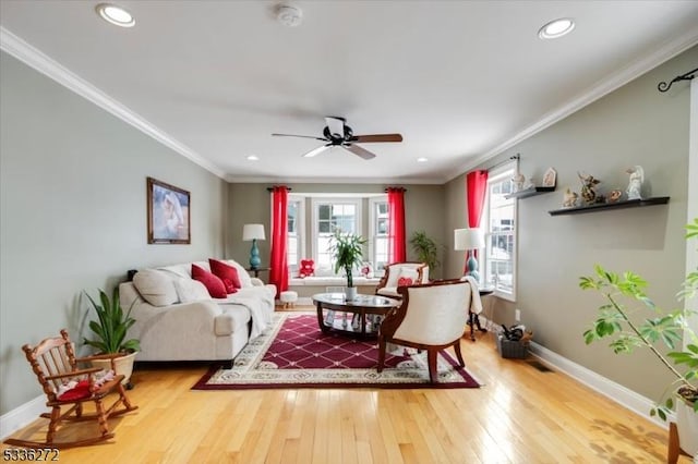 living room with crown molding, ceiling fan, and hardwood / wood-style floors