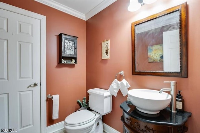 bathroom featuring crown molding, vanity, and toilet