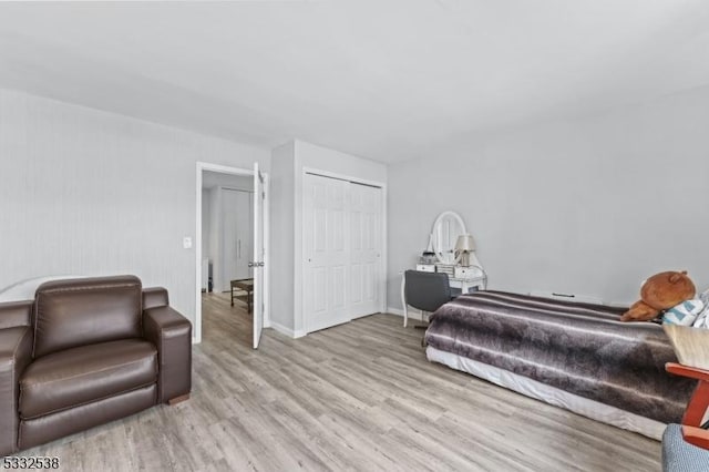 bedroom with a closet and light hardwood / wood-style flooring