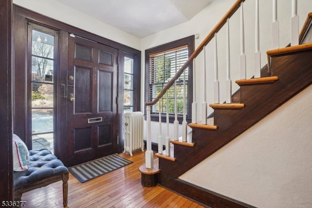 foyer featuring radiator and light hardwood / wood-style flooring