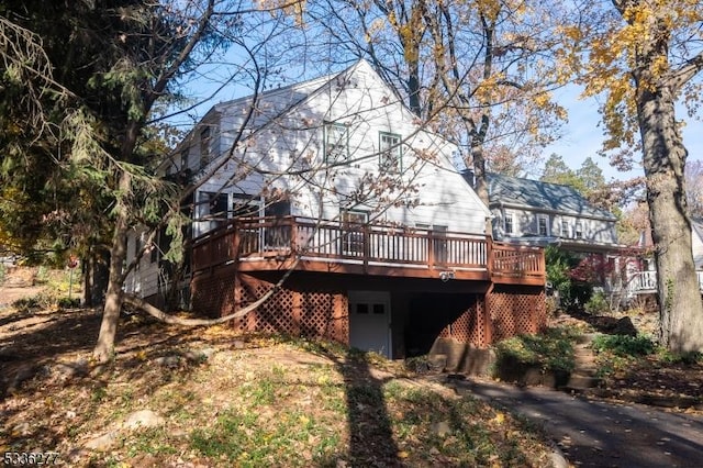 back of property featuring a wooden deck