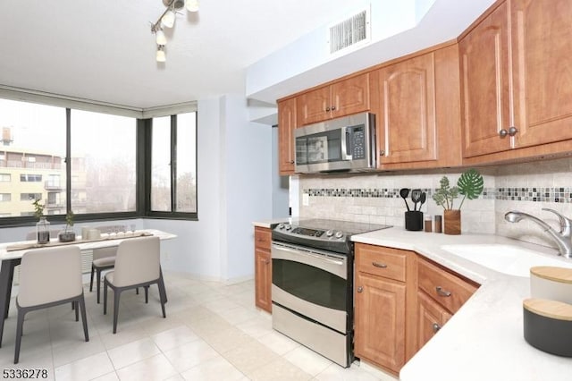 kitchen with tasteful backsplash, sink, and stainless steel appliances