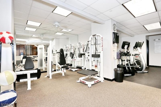 gym featuring a drop ceiling and ceiling fan