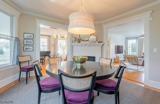 dining space featuring ornamental molding and wood finished floors