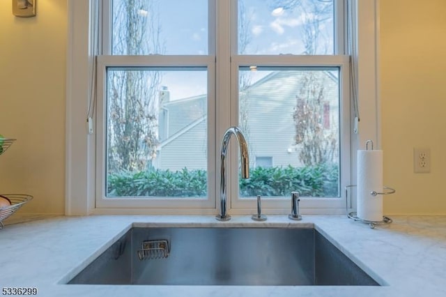 details with light stone counters and a sink