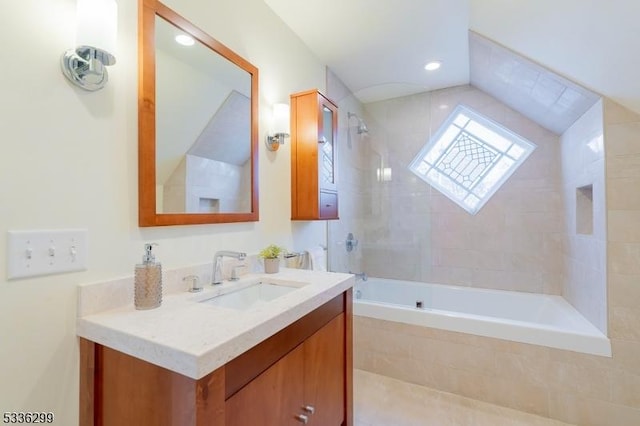 bathroom with tiled shower / bath combo and vanity