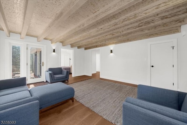 living room featuring beam ceiling and wood finished floors