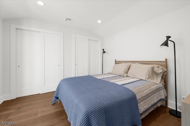 bedroom with visible vents, recessed lighting, wood finished floors, and vaulted ceiling