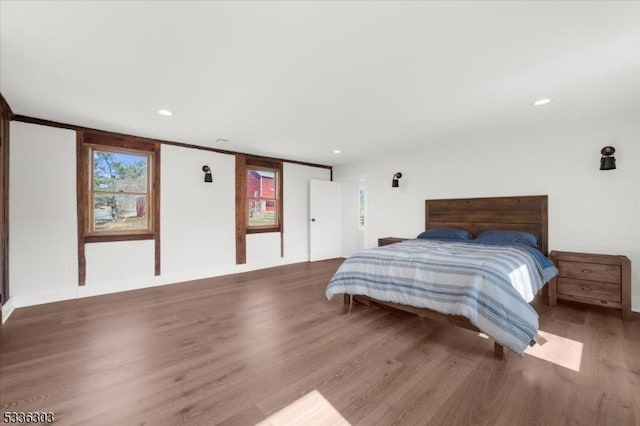 bedroom with recessed lighting and wood finished floors