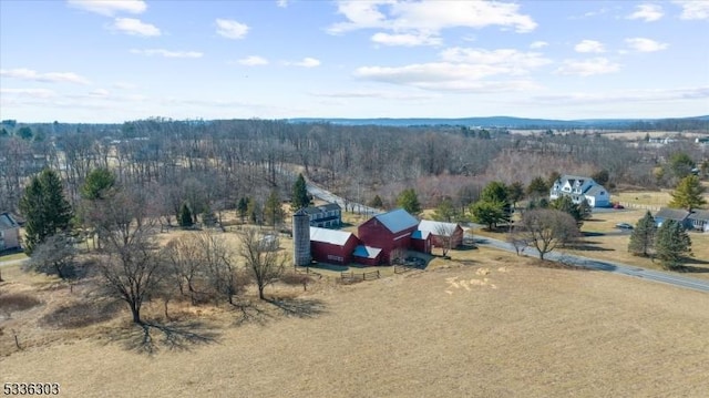 birds eye view of property with a rural view and a wooded view