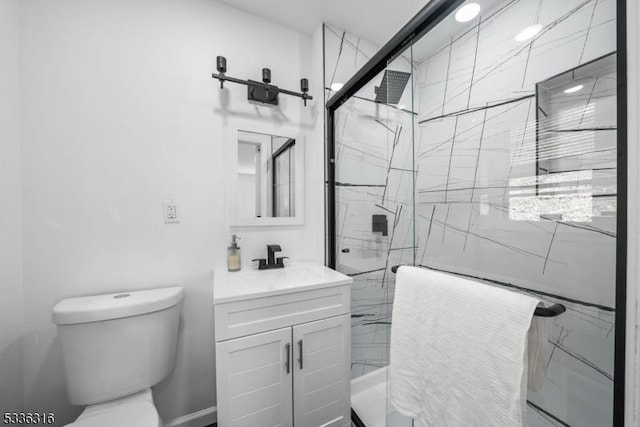 bathroom with vanity, toilet, and a shower with shower door