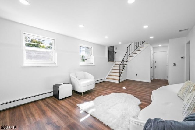 living room featuring dark wood-type flooring and baseboard heating