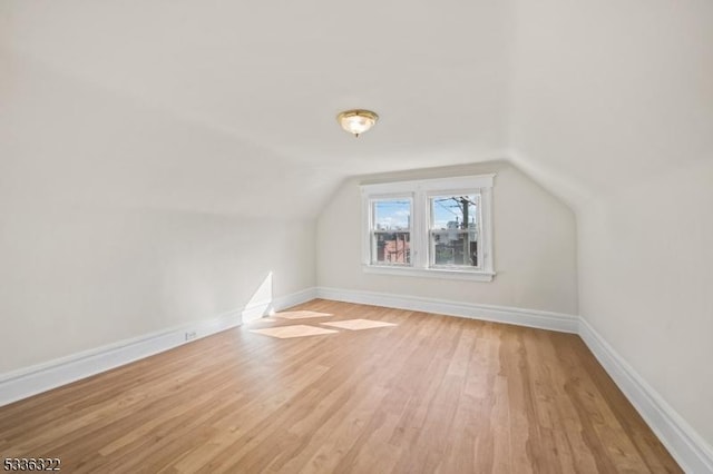 bonus room with vaulted ceiling and light hardwood / wood-style floors