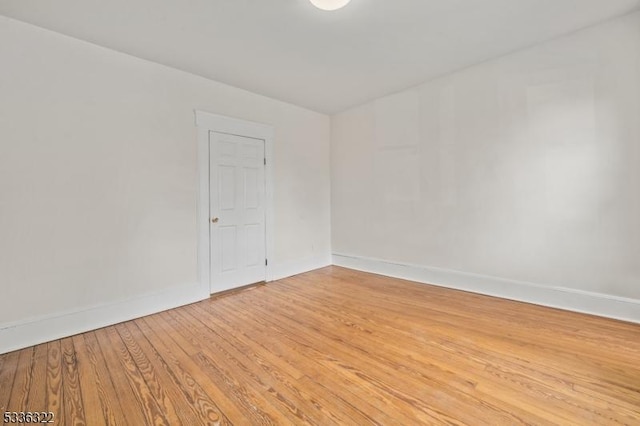 spare room with wood-type flooring