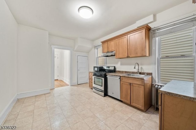 kitchen featuring appliances with stainless steel finishes, sink, and radiator heating unit