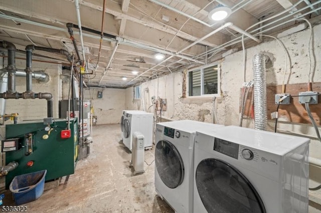 laundry area featuring water heater and washing machine and clothes dryer