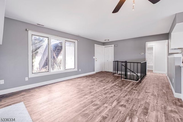 empty room featuring ceiling fan and hardwood / wood-style floors