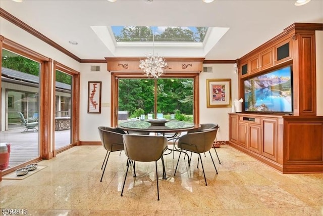 dining room with crown molding, a tray ceiling, a chandelier, and a skylight