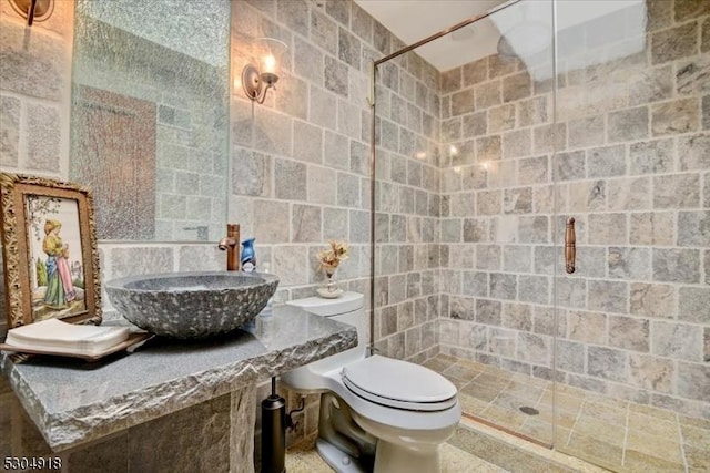 bathroom with toilet, an enclosed shower, sink, and tile walls