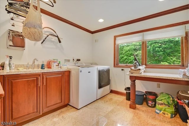 laundry area with sink, crown molding, cabinets, and washing machine and clothes dryer