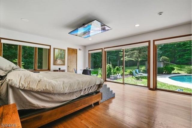 bedroom with access to exterior and light hardwood / wood-style floors