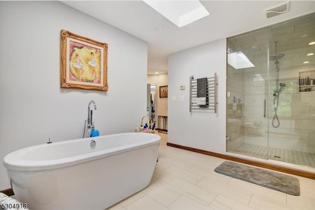 bathroom featuring a skylight and independent shower and bath