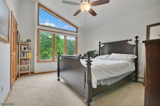 bedroom featuring baseboard heating, light colored carpet, ceiling fan, and vaulted ceiling