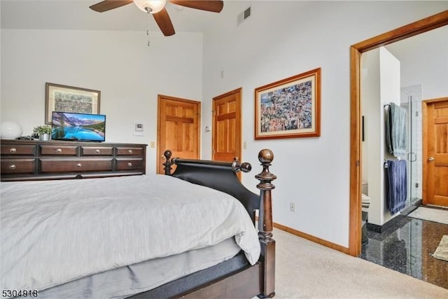 carpeted bedroom with ceiling fan and a high ceiling