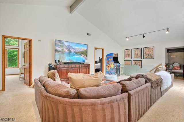 carpeted living room featuring track lighting, high vaulted ceiling, and beamed ceiling