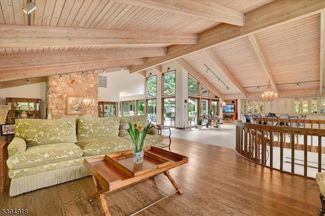 living room with an inviting chandelier, wood ceiling, high vaulted ceiling, hardwood / wood-style flooring, and beam ceiling