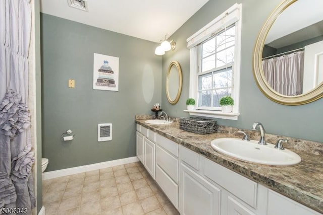 bathroom with vanity, tile patterned floors, and toilet