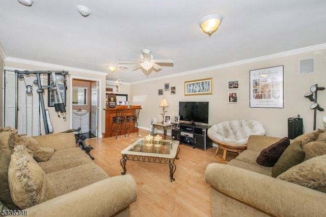 living room featuring crown molding, ceiling fan, and hardwood / wood-style floors