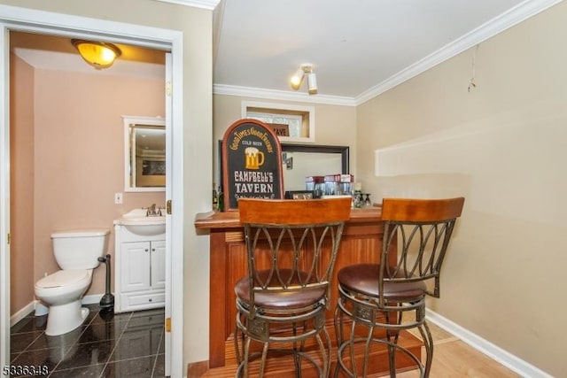 bar with sink and ornamental molding