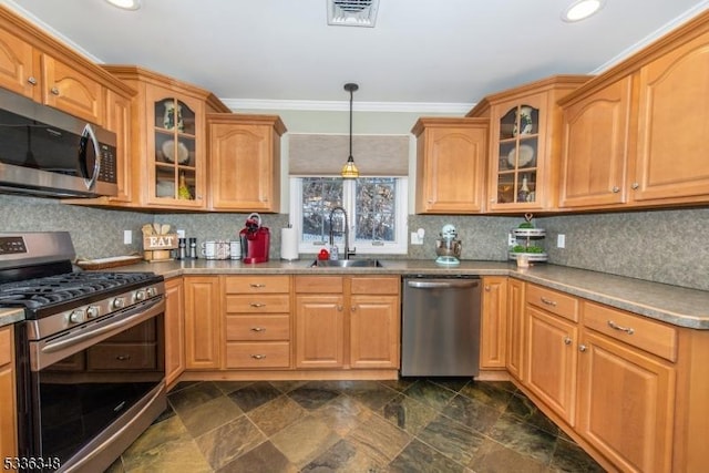 kitchen featuring sink, tasteful backsplash, decorative light fixtures, ornamental molding, and appliances with stainless steel finishes