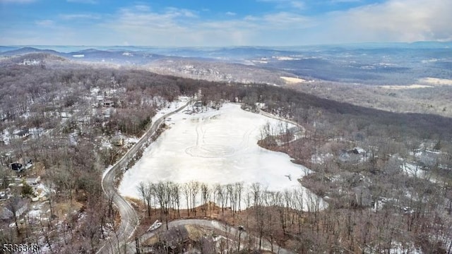 snowy aerial view with a mountain view