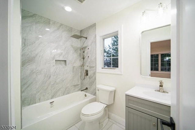 full bathroom with tiled shower / bath, vanity, and toilet