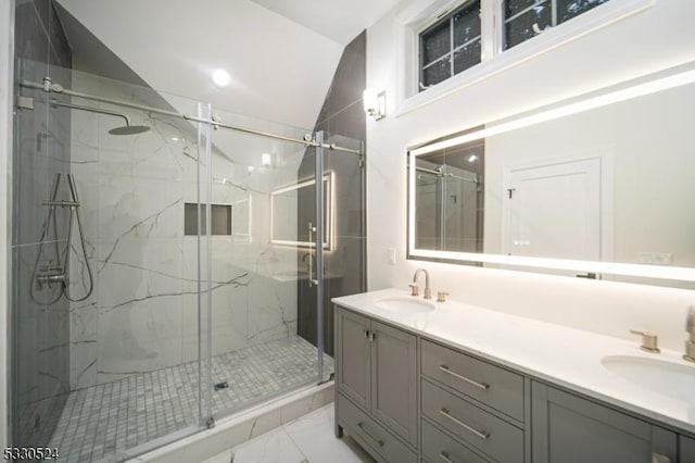 bathroom with vanity, vaulted ceiling, and a shower with shower door