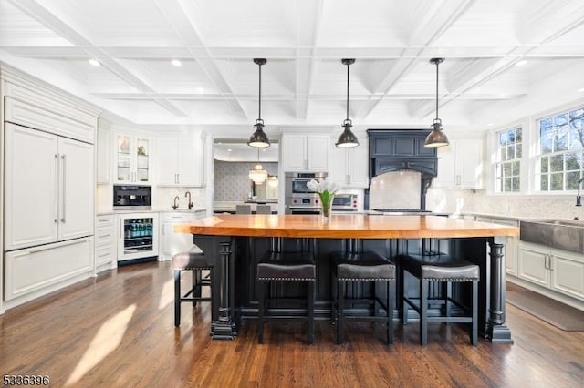 kitchen featuring beverage cooler, a sink, wood counters, white cabinetry, and dark wood finished floors