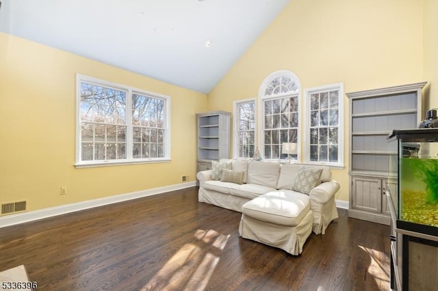 sitting room featuring dark wood-style floors, visible vents, high vaulted ceiling, and baseboards